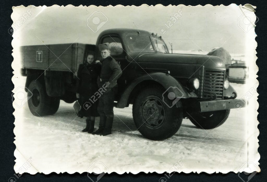 USSR - CIRCA 1950s : An antique photo shows man and woman near a military truck ZIL. "Soviet people" series